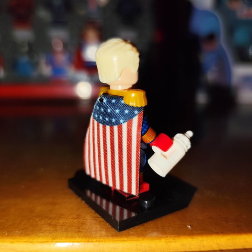 Homelander figure like new with base, two heads, cape, and bottle
