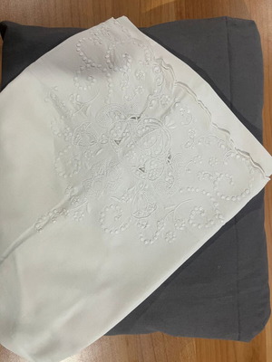 Single bed sheet set with grey fitted sheet and white embroidered pillowcase