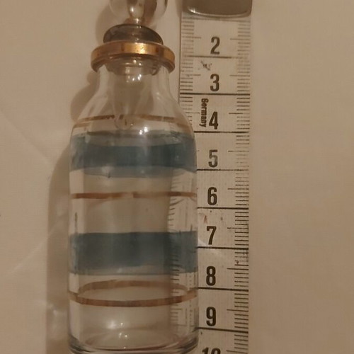 Vintage small glass bottle used with blue and gold stripes