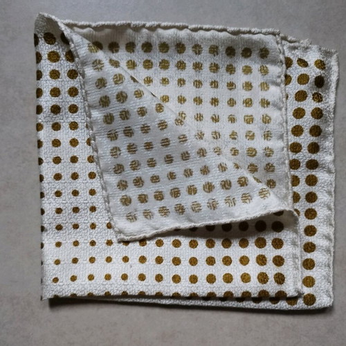 Pocket square used, white with gold dots