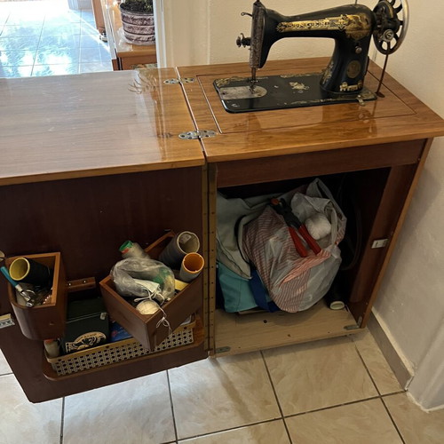 Singer sewing machine used with decorative cabinet