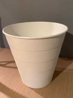 Trash bin used, white with small hole at the bottom