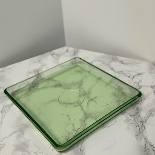 Serving tray or mat made of solid green glass used