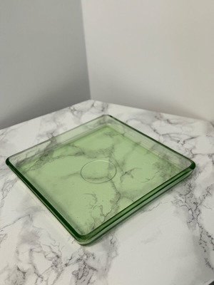 Serving tray or mat made of solid green glass used