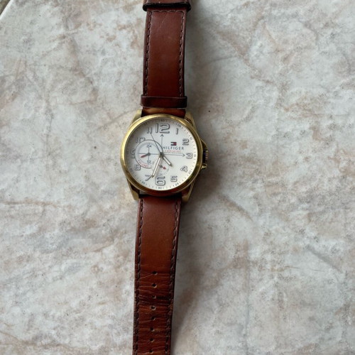 Tommy Hilfiger watch used with brown leather strap and gold dial