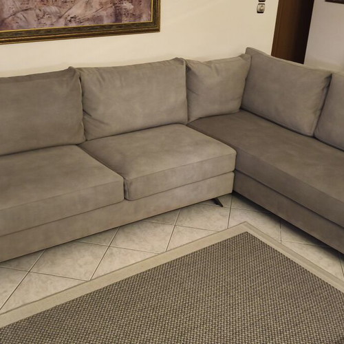 Corner sofa like new in grey/beige taupe color with decorative pillows