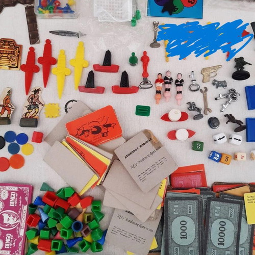 Lot of used game pieces, cards, and play money