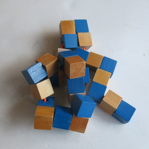 Wooden snake puzzle like new that transforms into a cube