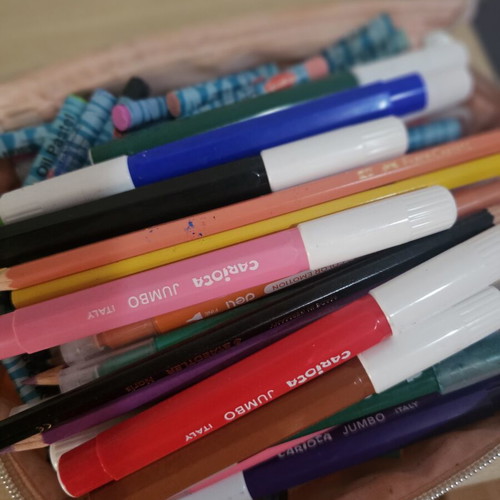 Makeup bag with markers, colored pencils, crayons, and watercolors used