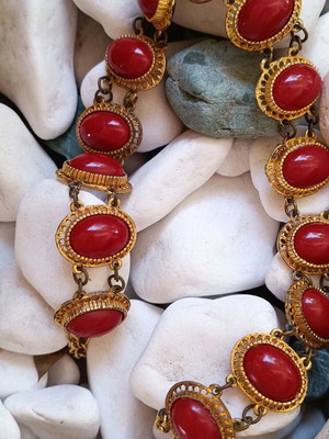Vintage necklace used with red stones and brass metal