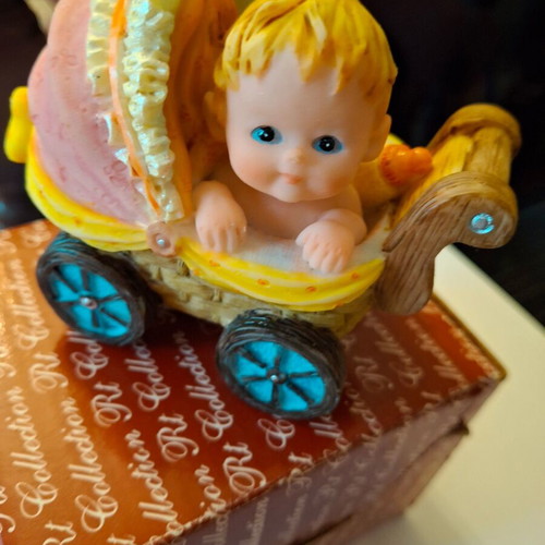 Decorative collectible baby stroller with baby and bottle like new