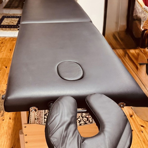 Portable folding massage bed with vinyl mattress, wooden frame