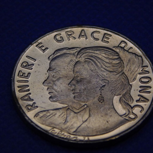 Commemorative metal token with Prince Rainier and Grace Kelly of Monaco