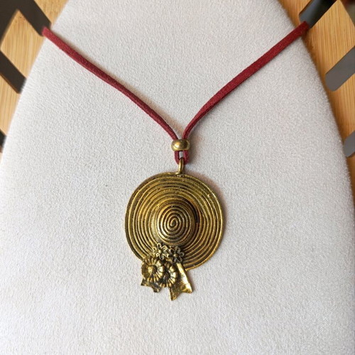 Long necklace with burgundy strap and gold vintage hat pendant