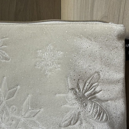 Apivita white velvet collectible toiletry bag with embossed bees and snowflakes