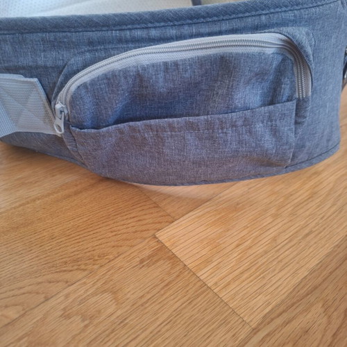 Gabesy ergonomic hip seat carrier used with branded baby toys