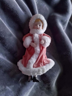 Porcelain doll used with pink velvet coat and faux fur trim