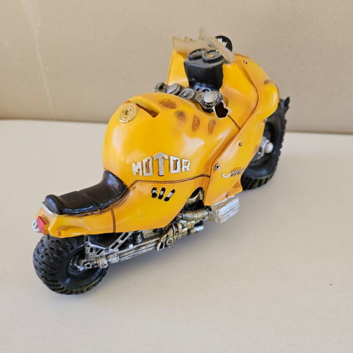 Motorcycle figure piggy bank used with crashed design