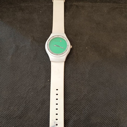 Swatch watch used with white silicone strap and green dial
