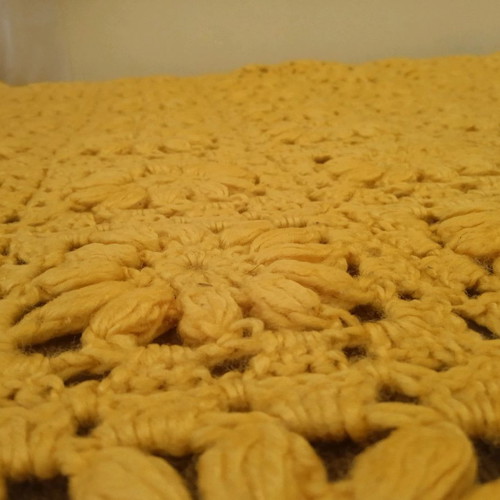 Knitted handmade blanket used with embossed daisies
