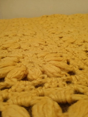Knitted handmade blanket used with embossed daisies