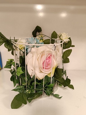 Decorative birdcage used with artificial flowers