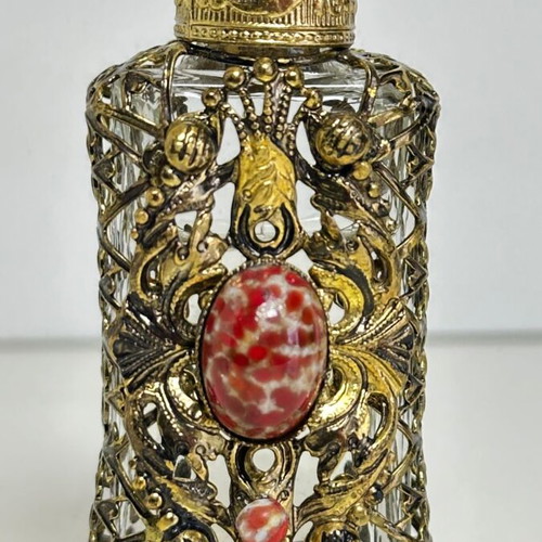 Vintage perfume flacon with filigree metalwork and red cabochon