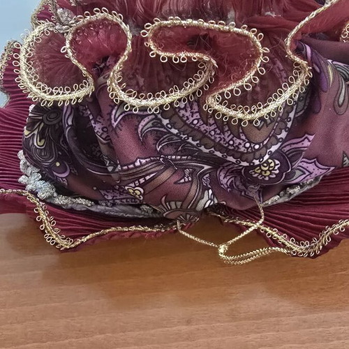Decorative porcelain wall mask used with fabric hat in burgundy