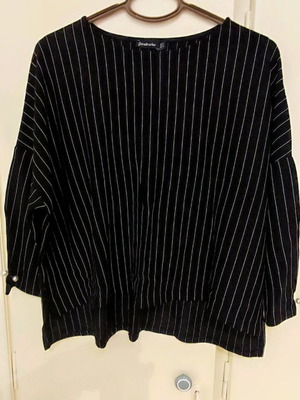 Women's blouse used black with thin white stripes and pearl details
