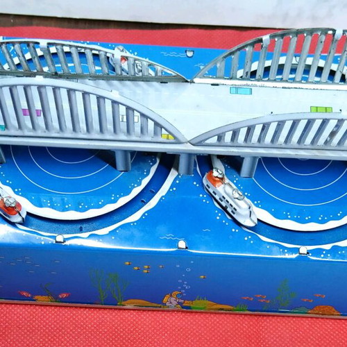 Tin wind-up toy used with key and moving boats