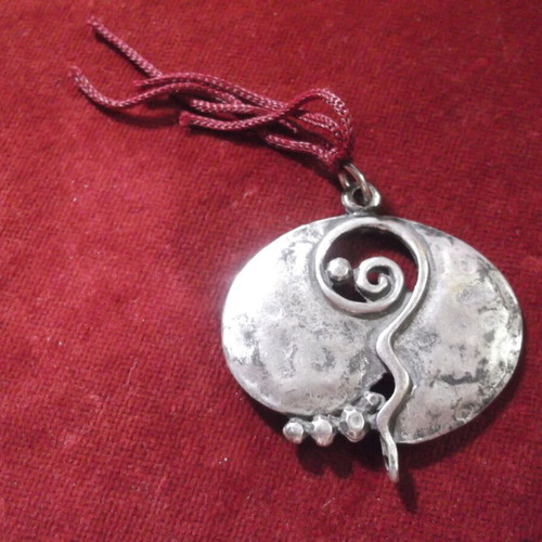 Metal round gouri charm with pomegranate decoration used, silver color