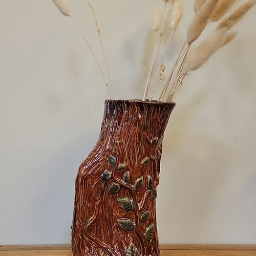 Handmade ceramic vase with natural decorative elements