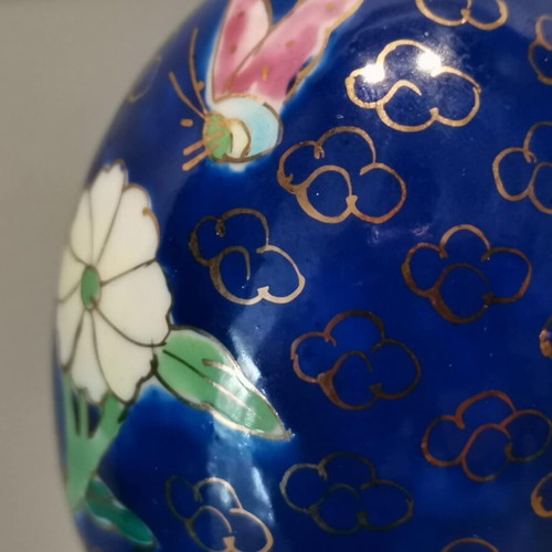 Porcelain egg used with hand-painted flowers and decorative butterflies