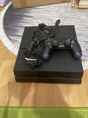 Sony PlayStation 4 (PS4) 1TB console used with controller and cables