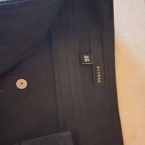 Access black pants like new with details on back pockets