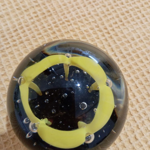 Vintage glass paperweight with yellow dome design