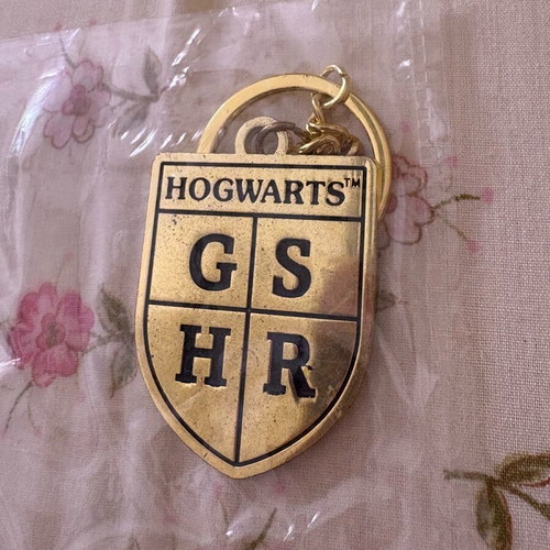 Harry Potter keychain new, gold with Hogwarts houses
