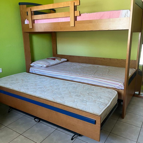 Wooden bunk bed with third sliding bed and mattresses like new