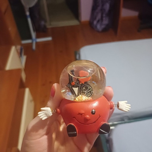 Vintage decorative snow globe with red winking character