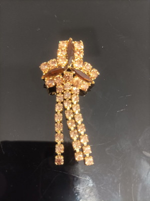 Antique costume jewelry brooch with yellow and maroon stones