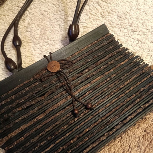 Wooden bag with slightly faded strap