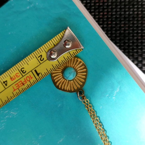 Steel necklace like new with blue mataki stone gold color