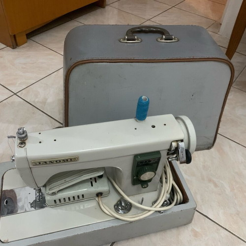 Electric collectible sewing machine used with carrying case
