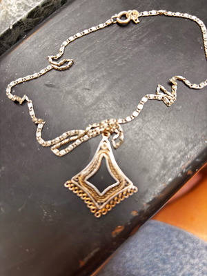Silver vintage pendant with intricate chain