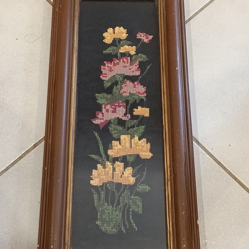 Vintage handmade embroidered textile painting in frame with glass