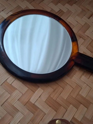 Double-sided handheld mirror, normal and magnifying