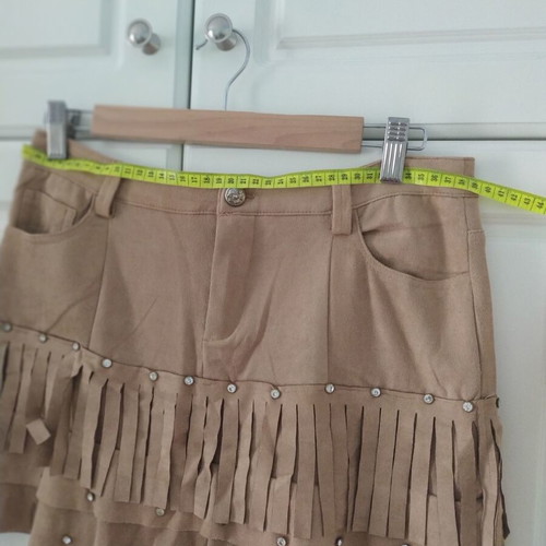 Skirt used with suede-type fringes and matte antique gold details
