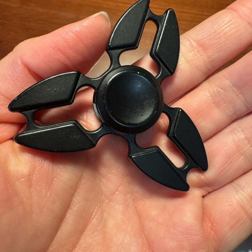 Metal fidget spinner used, black ninja star shuriken design