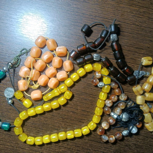 Worry beads like new, all together, in green, brown, yellow, orange