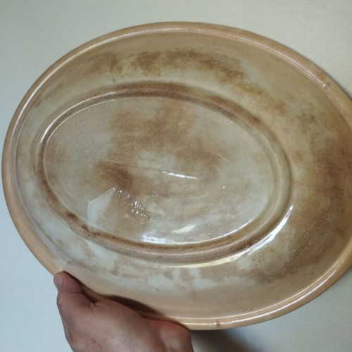 Handmade beige platter with green used, aged wear